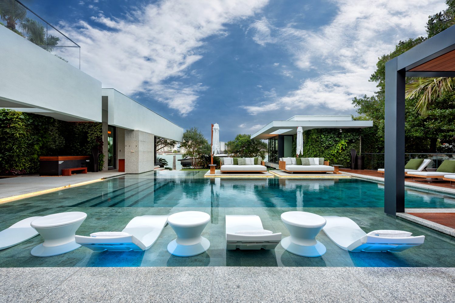 In-pool loungers on a sun shelf in a renovated pool