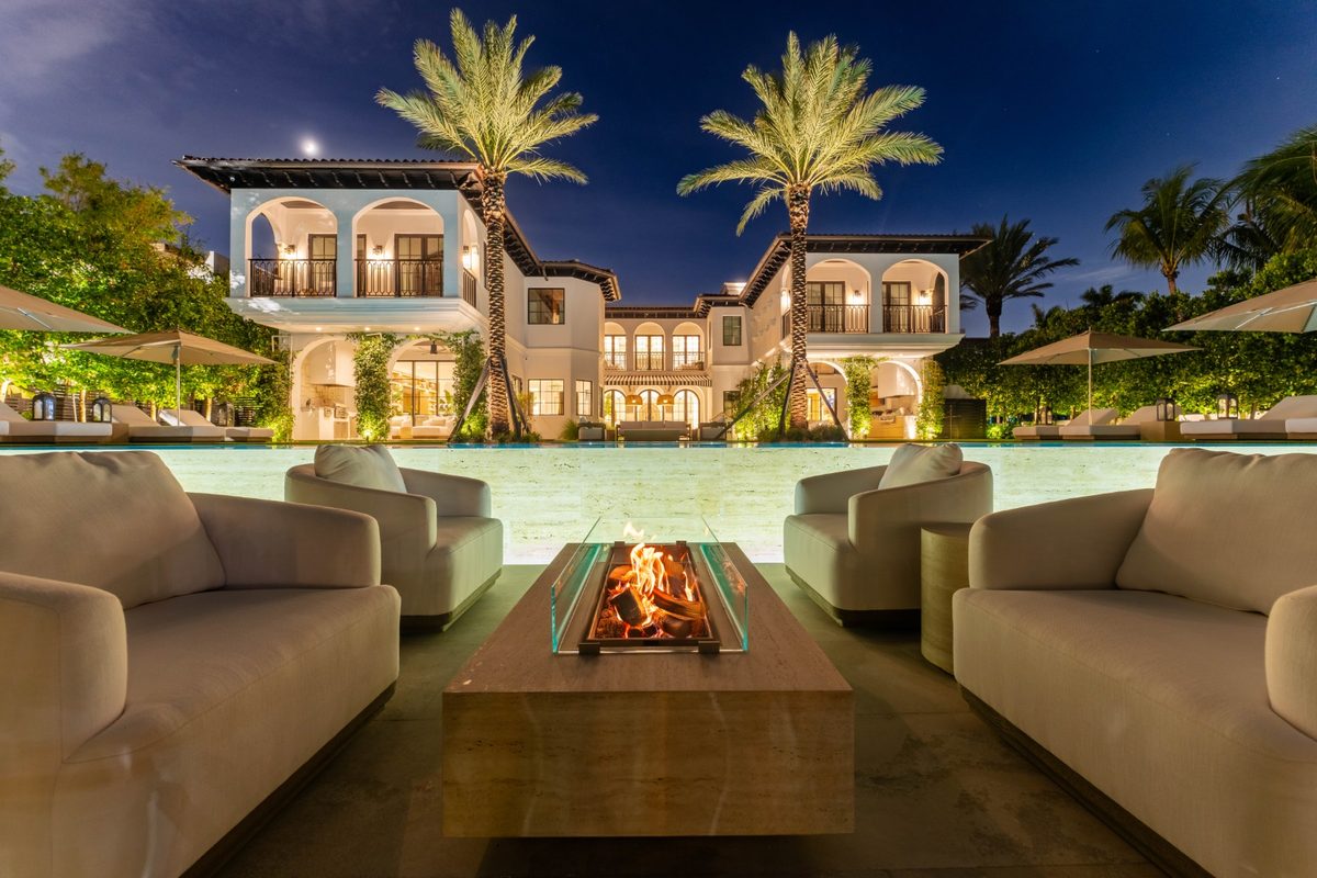 Outdoor lounge with a fire table beside the pool