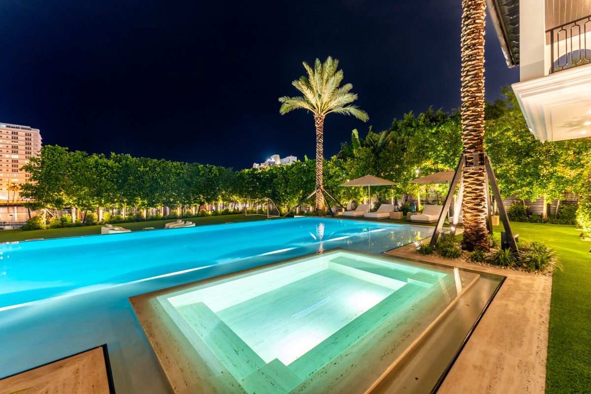 Raised spa beside the pool with the skyline behind