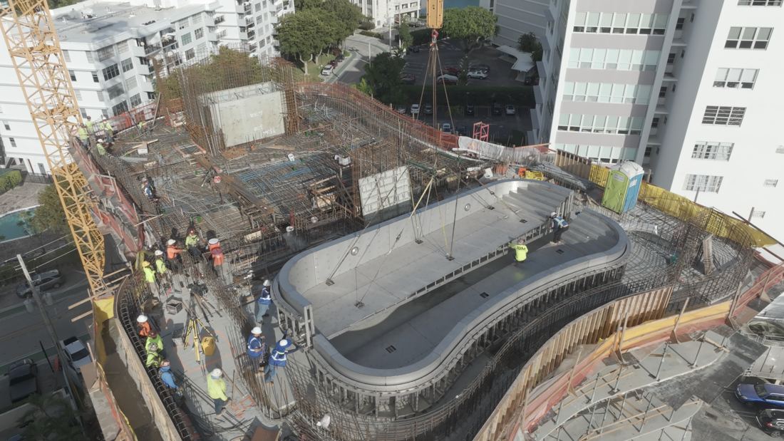 Drone view of the curved stainless steel pool shell on the roof