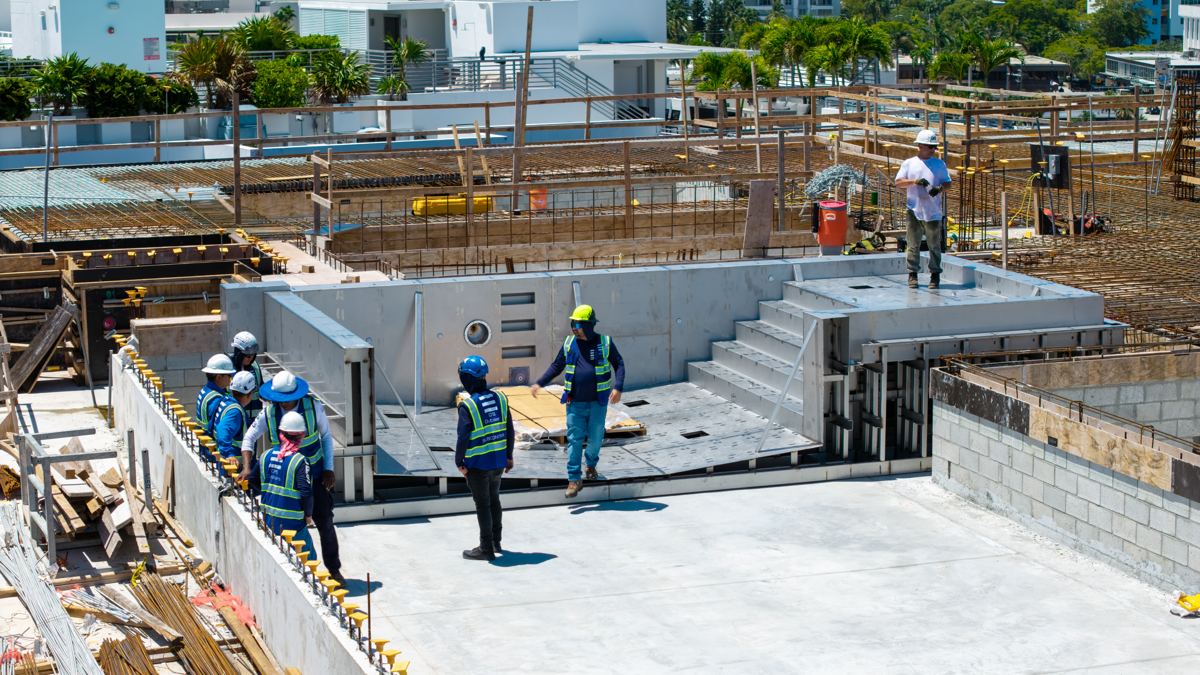 Crew working inside a set stainless steel pool section