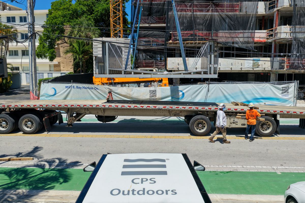 Stainless steel pool sections arriving on a flatbed truck