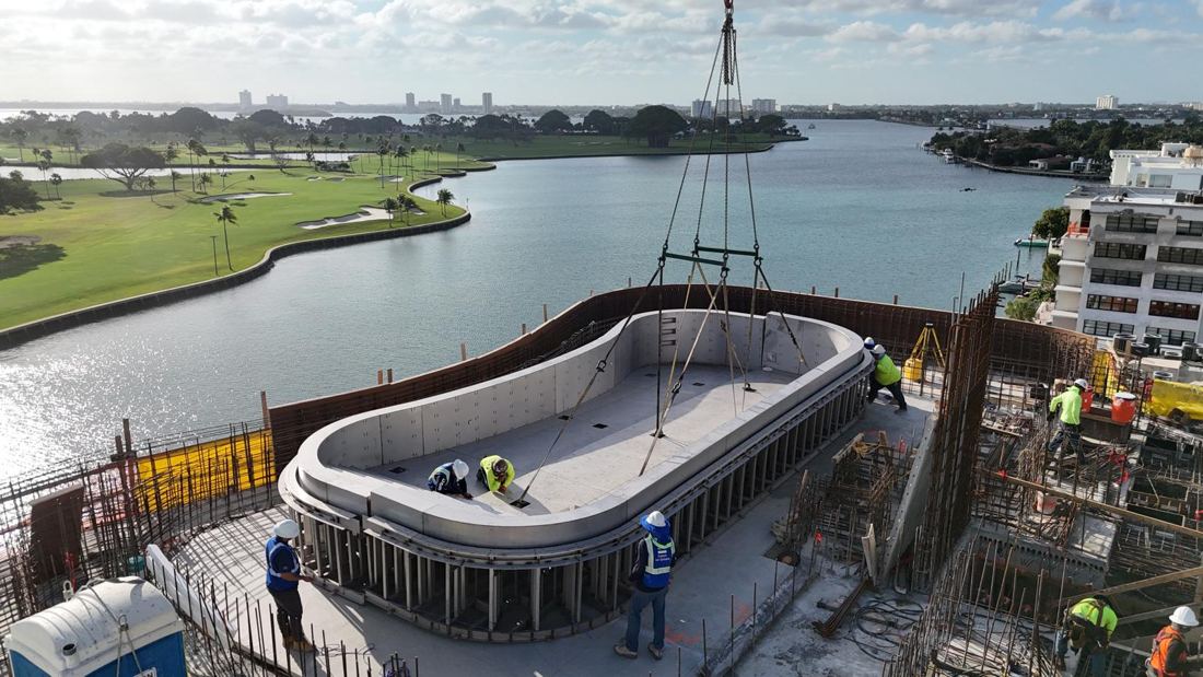 Crew setting the pool shell on the rooftop deck